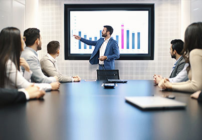 team meeting with presenter in front of a screen