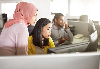 two women over looking a monitor